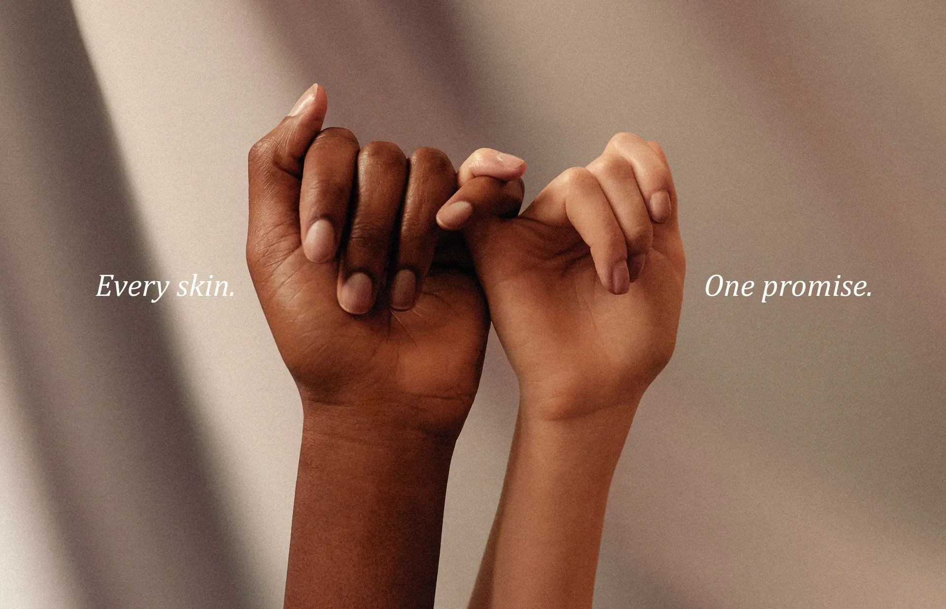 Freja Instagram campaign post of two people's hands intertwined, reading Every skin. One promise.