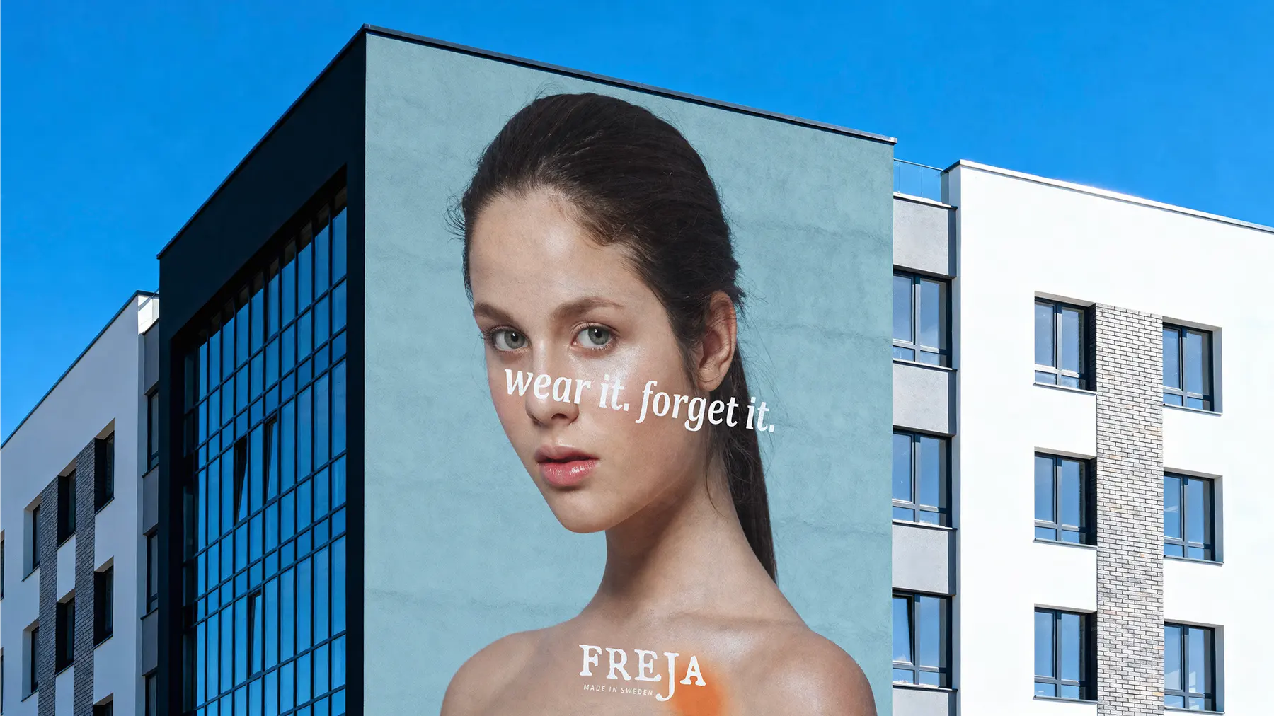 Subway platform billboard ad for Freja reading wear it. forget it., black frame on white tile