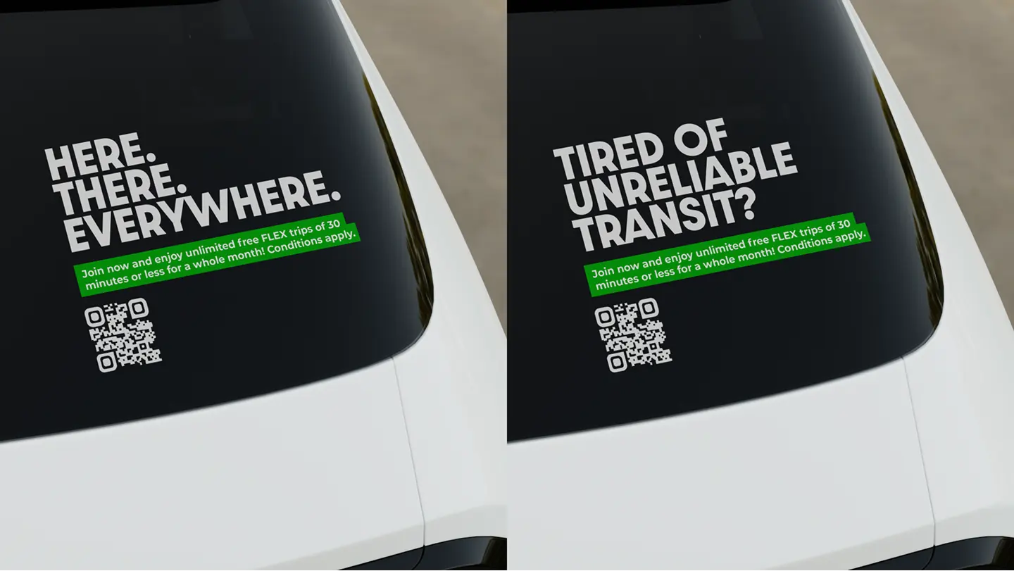 Building-side billboard ad for Communauto reading Cars on Demand, No Hassles, No Extra Fees, above a photo of a smiling driver, with Google Play and App Store badges