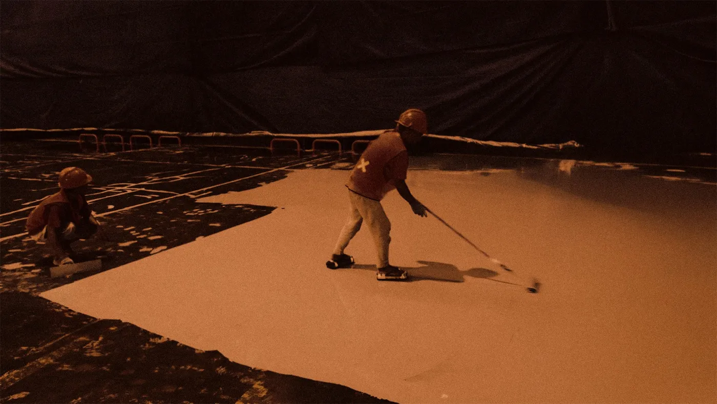 A Mella Paint crew spreading self-levelling epoxy at night